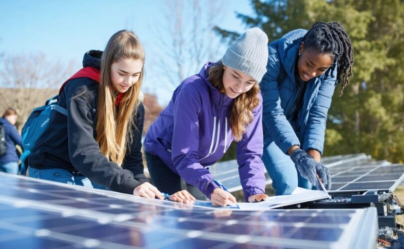 Group of University of Virginia students engaged in hands-on solar panel training during the winter session, showcasing intensive learning in renewable energy.