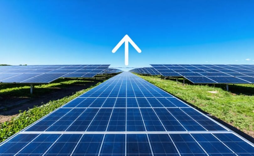 A futuristic solar panel farm under a clear blue sky symbolizes advancements in solar efficiency, with a symbolic upward arrow representing innovation in renewable energy technologies.