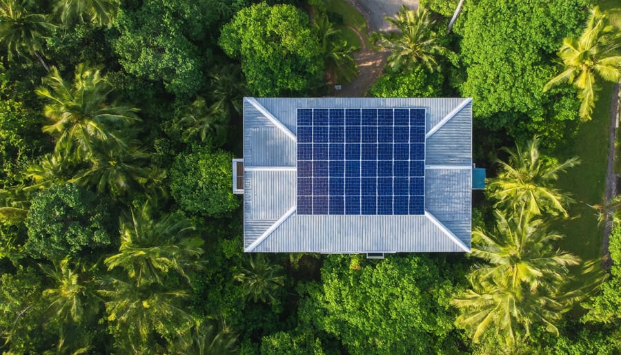 Off-grid solar panels installed on a Hawaiian home surrounded by lush tropical vegetation