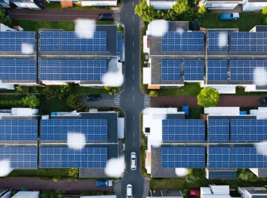 A residential neighborhood showcasing rooftops adorned with parallel-connected solar panels, seamlessly integrated into a smart grid system for enhanced power management and efficiency.