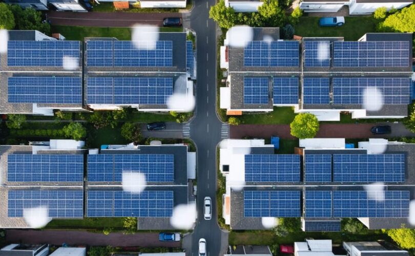 A residential neighborhood showcasing rooftops adorned with parallel-connected solar panels, seamlessly integrated into a smart grid system for enhanced power management and efficiency.
