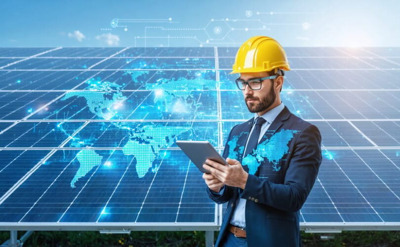 System integrator using a tablet to manage and monitor solar PV installation, with digital graphics representing data and connectivity illustrating digital transformation in solar energy operations.