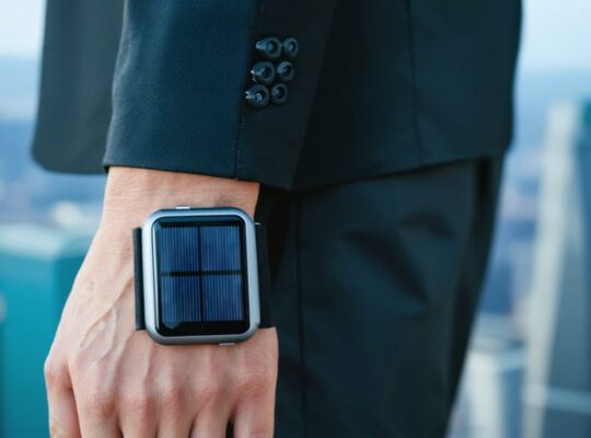 "Close-up of a futuristic wearable solar device on a wristband highlighting its flexible, energy-efficient design against an urban background."